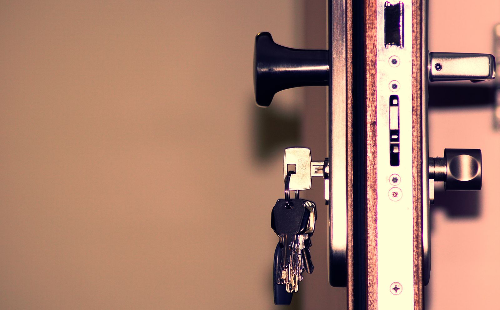 A locksmith opening a locked residential door without damaging it