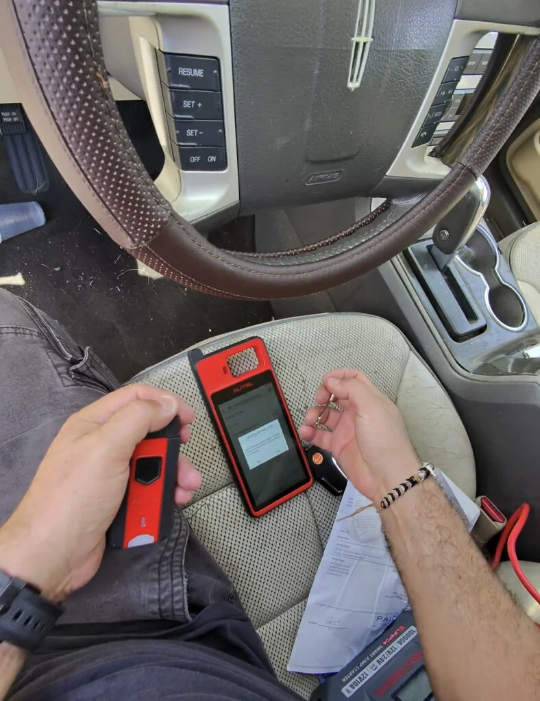 Locksmith programming a car key on site in West Palm Beach